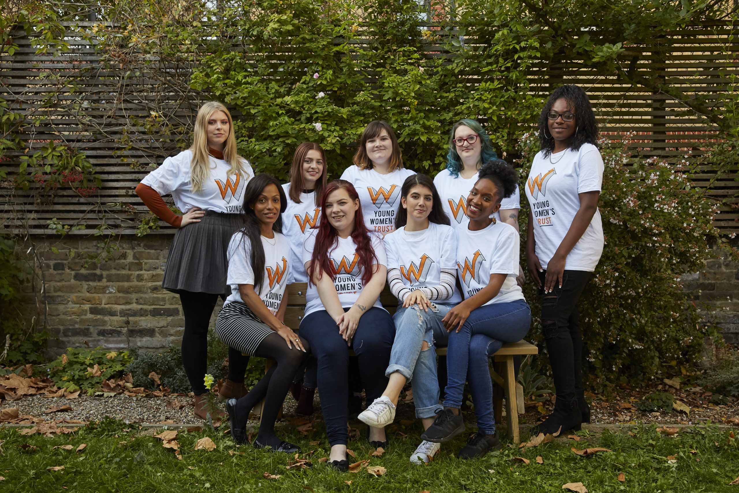 A group of women wearing Young Womens Trust t-shirts