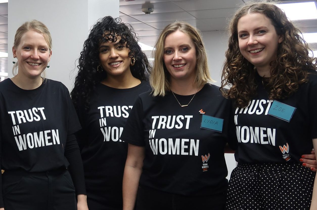 A group of women wearing Young Womens Trust t-shirts