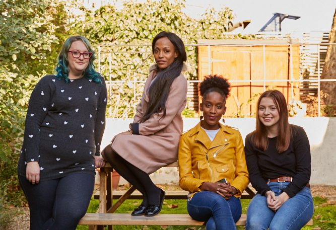 A group of young women sitting on a bench