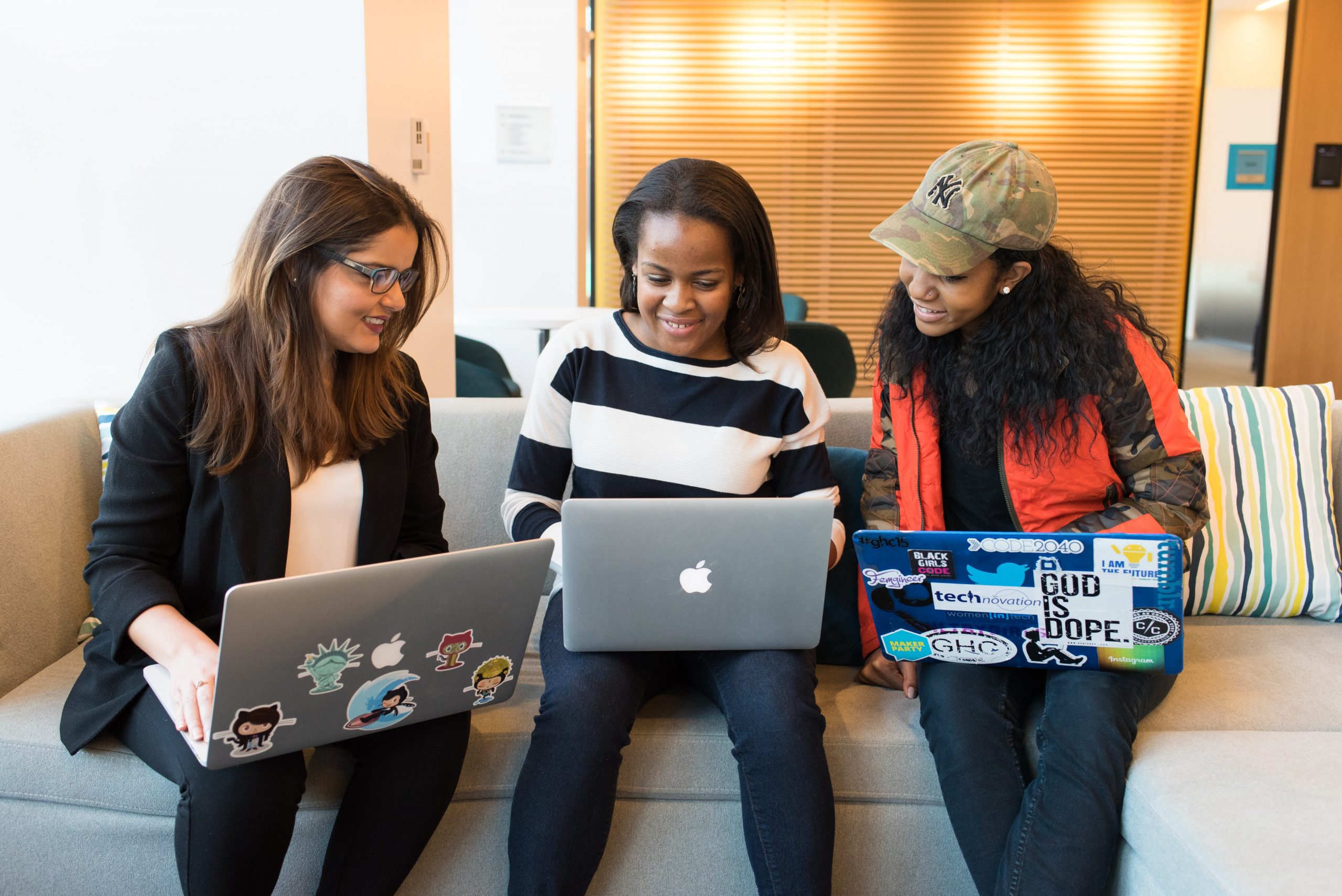 3 young women on their laptops