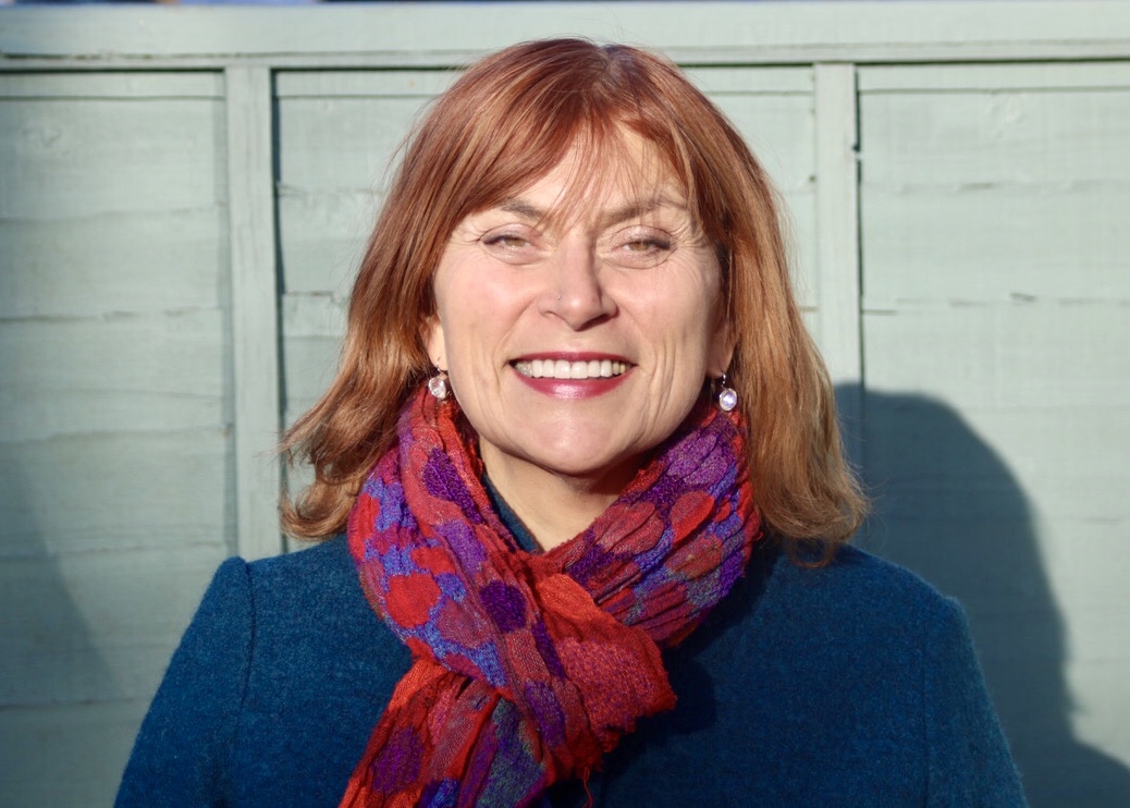 The image shows Carole a Young Women's Trust Coach facing the camera and smiling