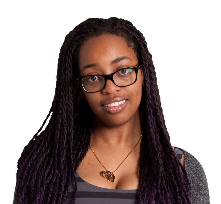 A woman wearing glasses looks directly at the camera