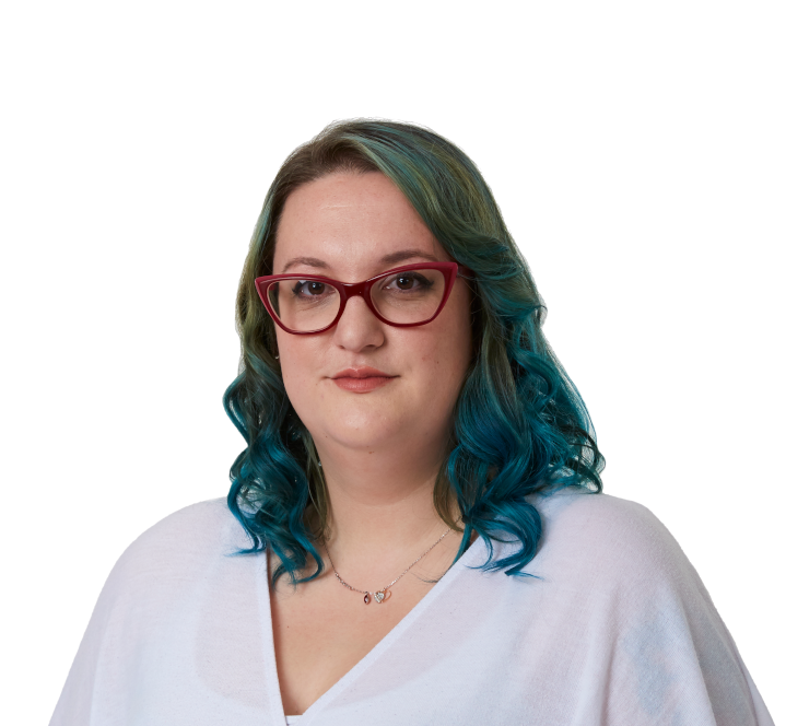 A young woman with green dyed hair looks frankly at the camera