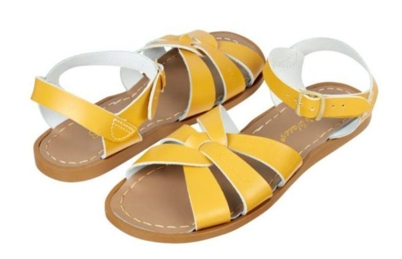 A pair of yellow Salt Water Sandals x Young Women's Trust