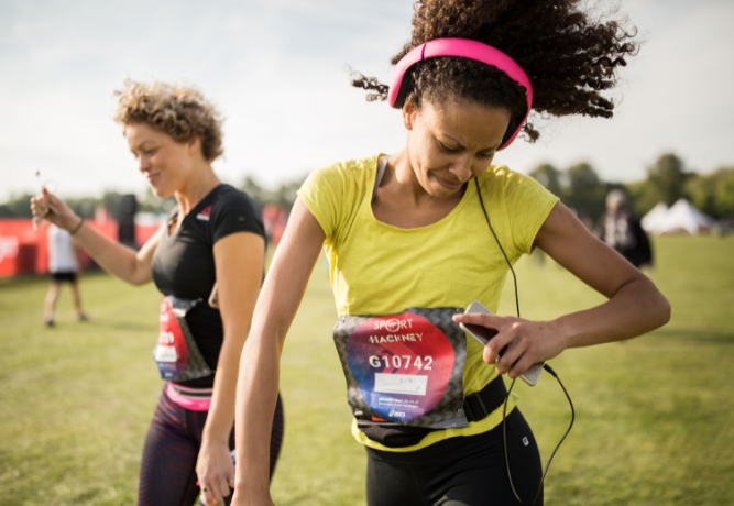 Two smiling runners getting ready to do the Hackney Half Marathon
