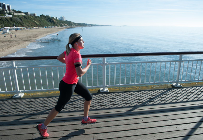 a woman running alongside the sea